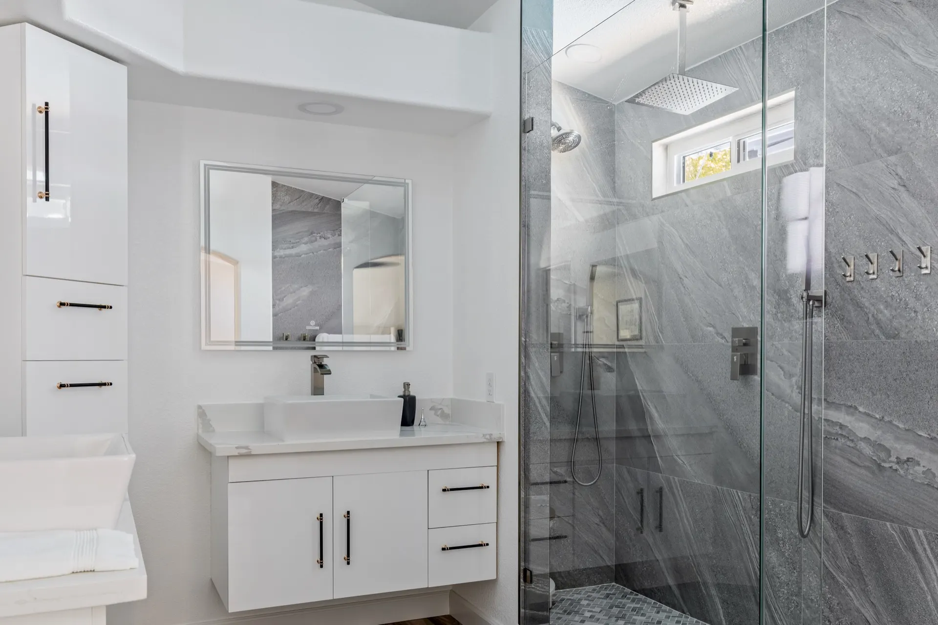 The same bathroom as built, in white and gray stone